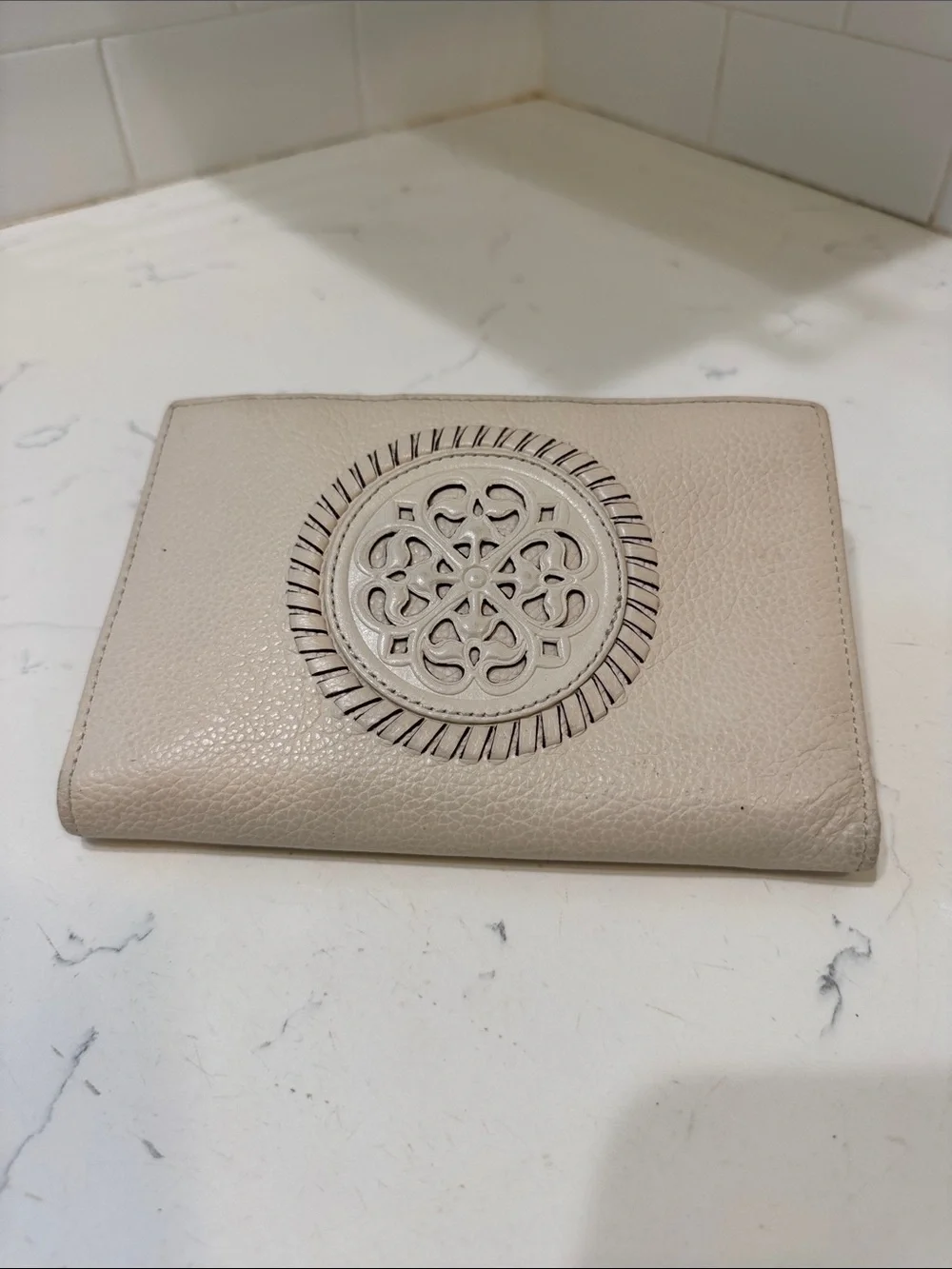 Brighton Cream Pebbled Leather Ferrara Fold Wallet with Embossed Medallion